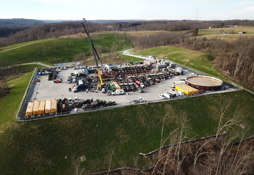 Overhead photo of a natural gas drilling operation amid rolling hills in rural Ohio.
