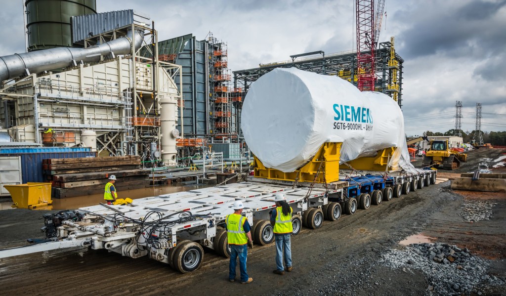 A natural gas turbine is delivered on a large, double-wide truck trailer to a Duke Energy power plant in North Carolina.